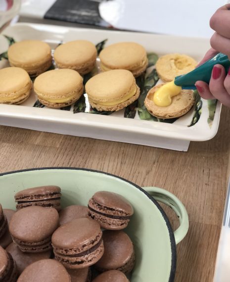 piping buttercream into macarons