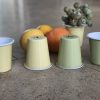 small pale green and lemon enamel tumblers