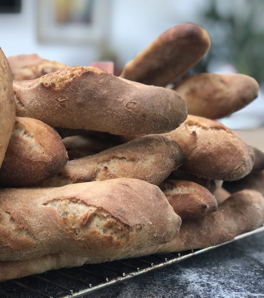 fresh homemade baguettes piled up