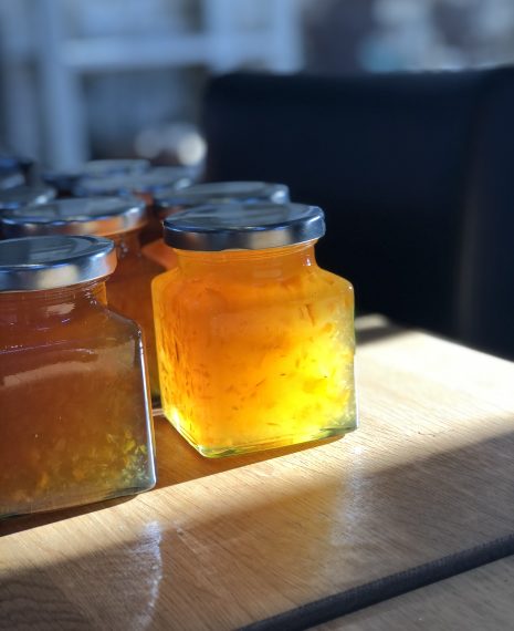 jars a freshly made marmaladde with the sun shining through
